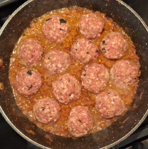 Koftas in pan being cooked