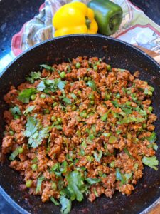 Freshly chopped coriander added to chicken keema