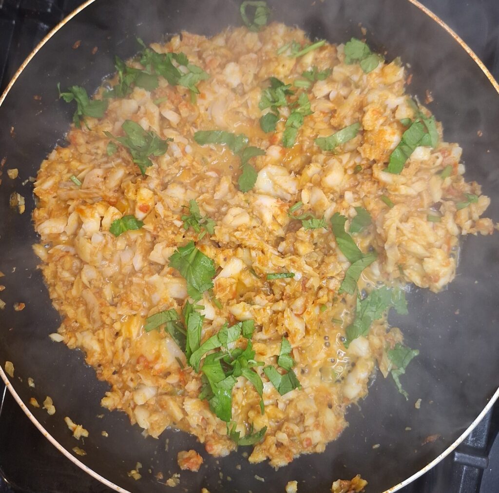 Add freshly cut coriander to the fish curry