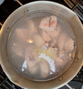 Chicken being added to boiling water
