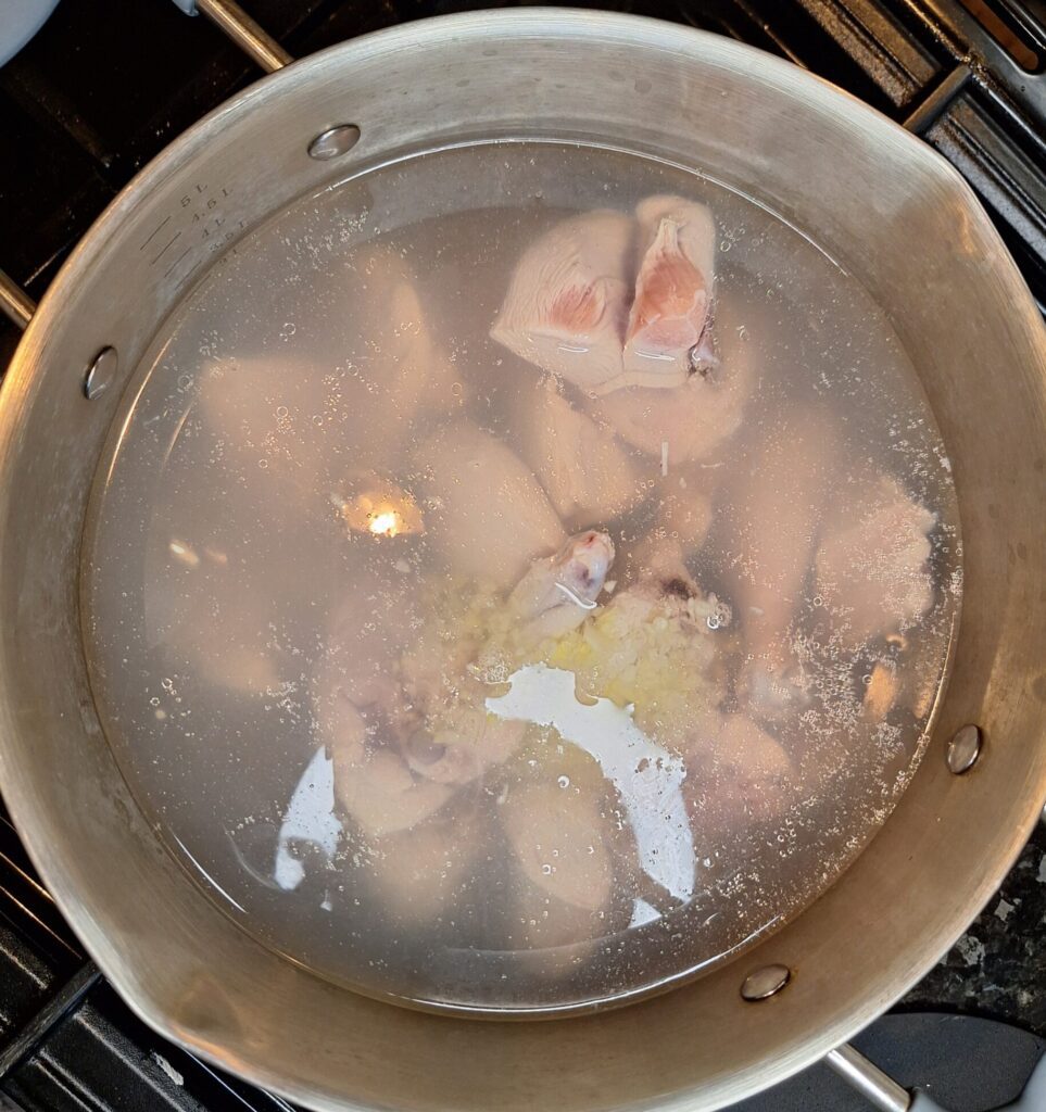 Chicken being added to boiling water