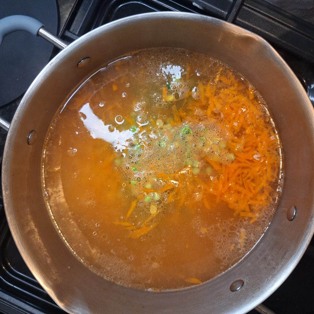Add grated carrots, peas and sweetcorn to the pan