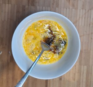 Whisked egg, soya sauce and vinegar mixed in bowl