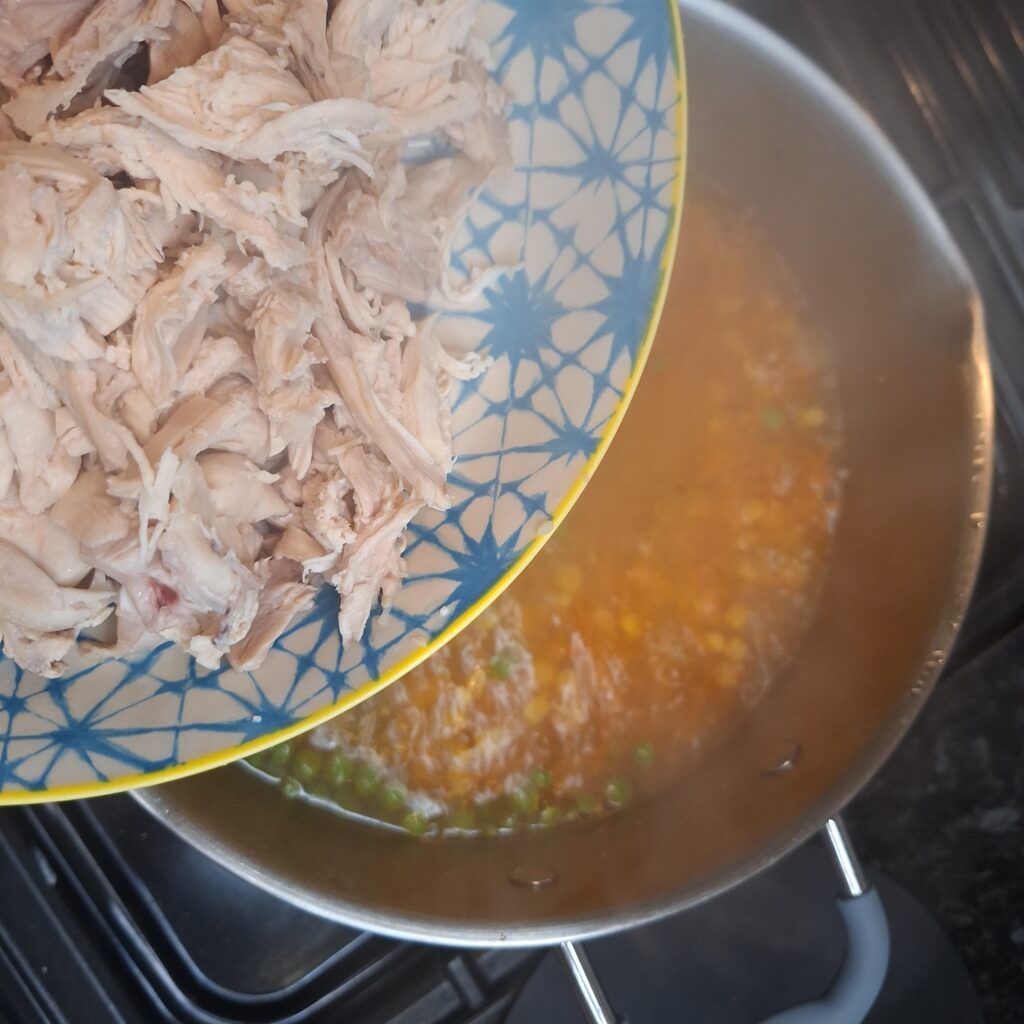 Add shredded chicken to the pan