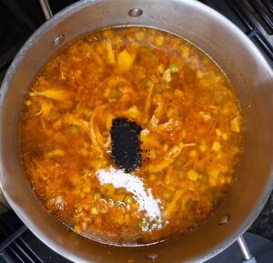 Add black pepper, green chillies and nigella seeds to the pan
