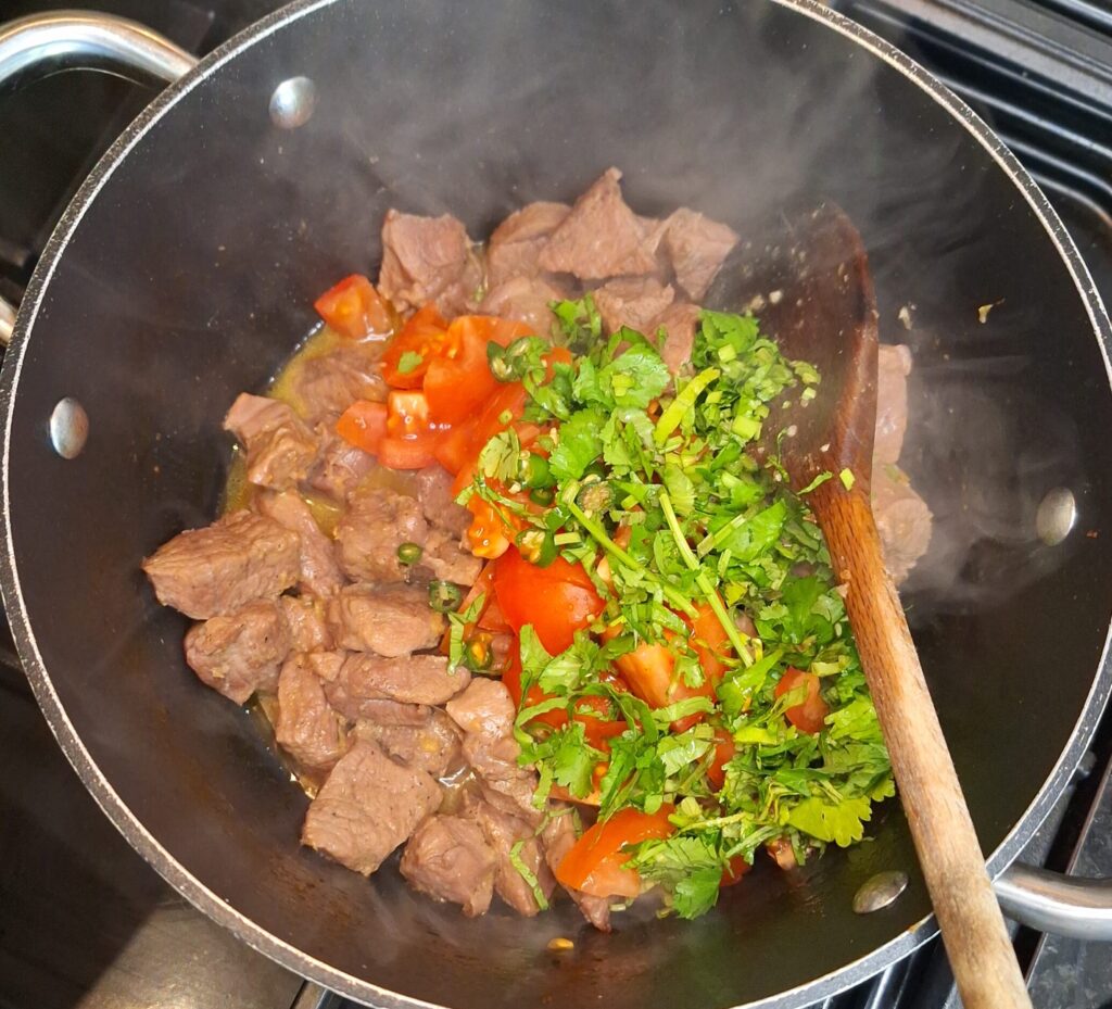 Add tomatoes, chillies and fresh coriander