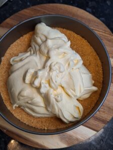 Mango cheesecake mix added to biscuit base