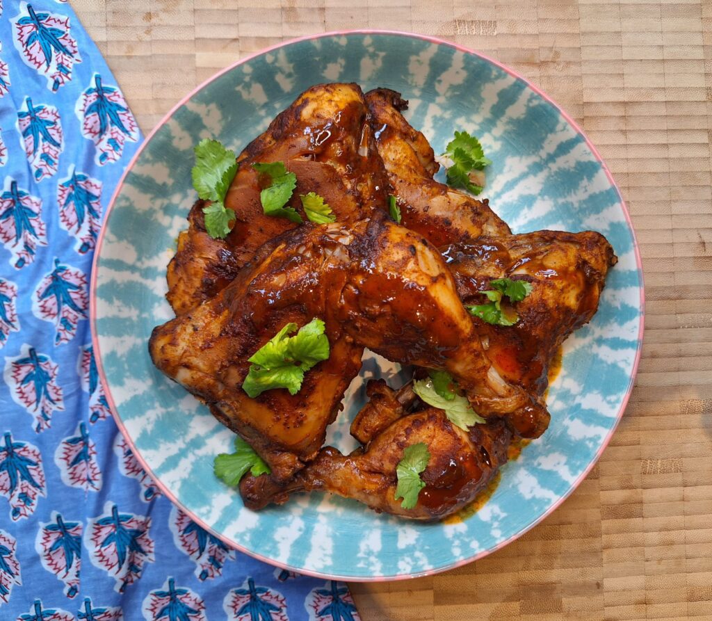 Spicy roasted chicken legs fresh from the oven.