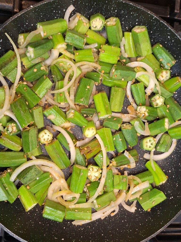 Shallow fry ladyfingers with onions, lemon juice and coriander seeds