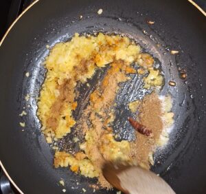 Add spices to the browned onions