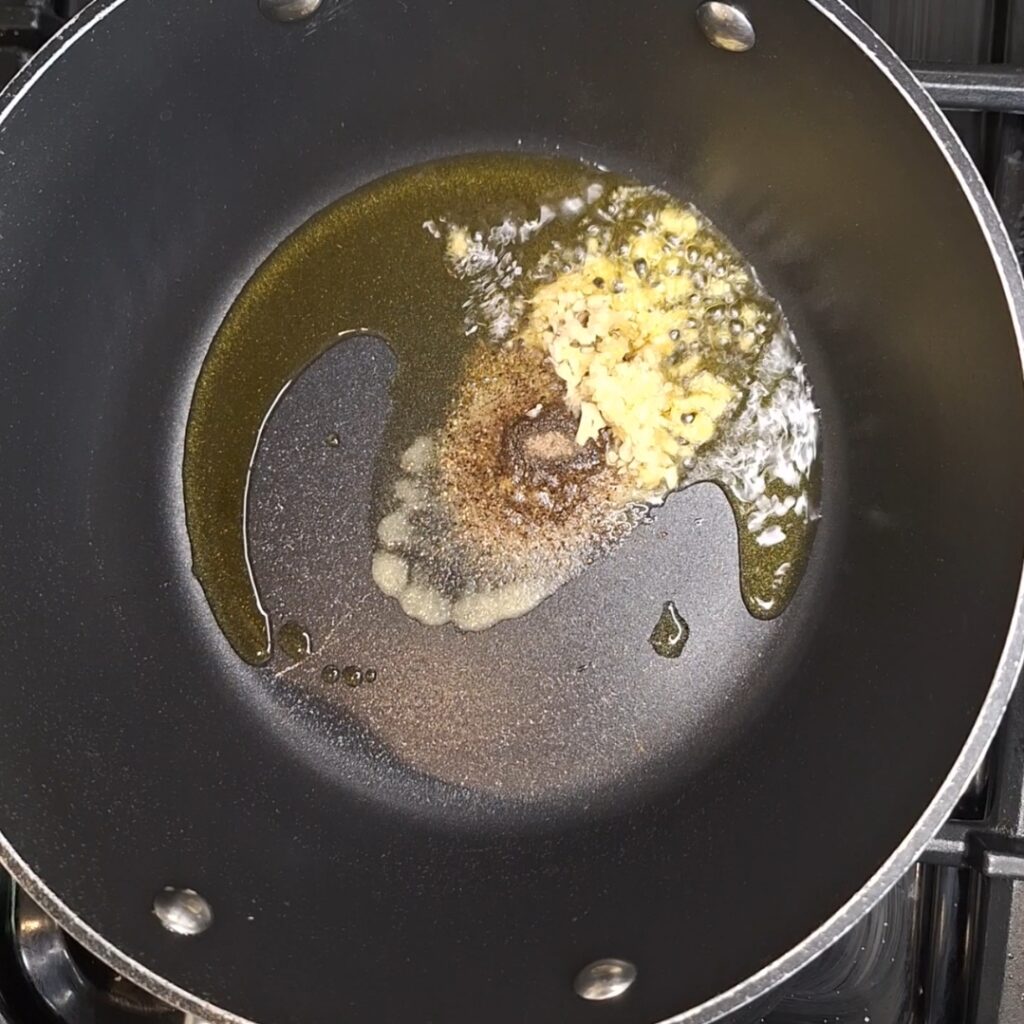 Add spices and garlic and ginger to pan