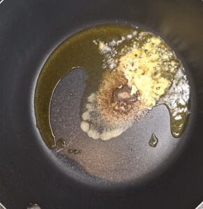 Add spices and garlic and ginger to pan