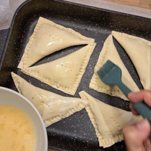 Keema pastries ready to bake, with egg wash applied