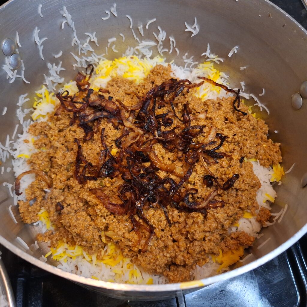 Layering of rice and mince lamb