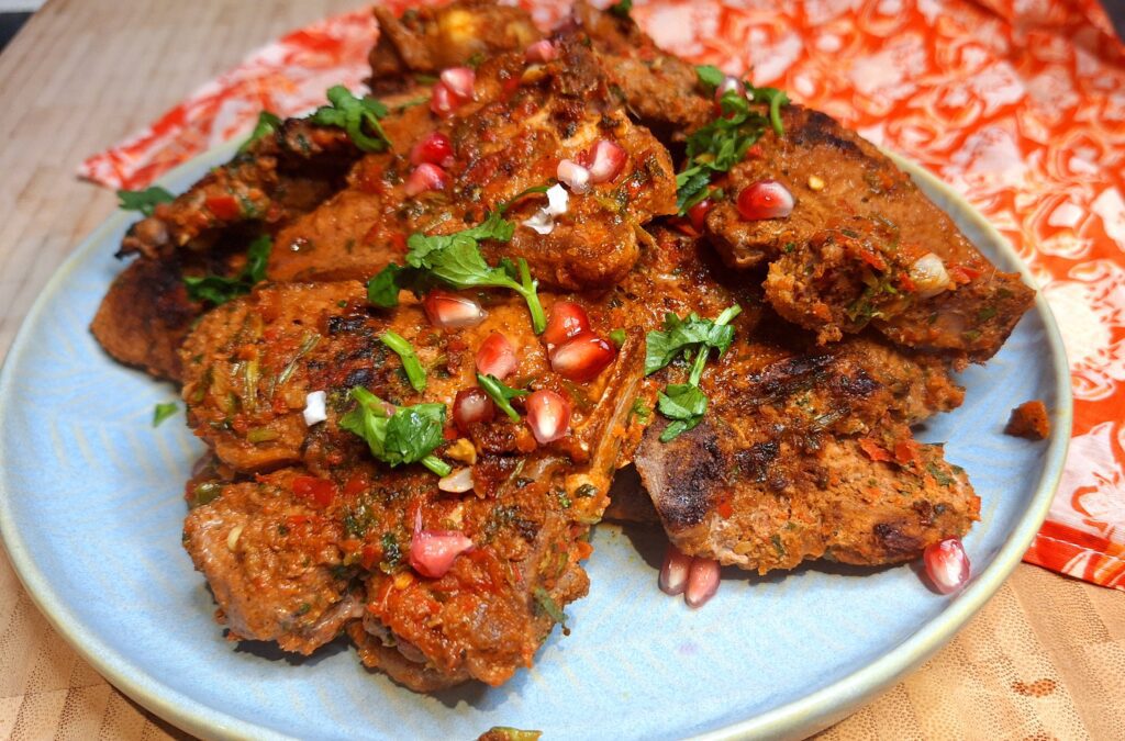 Juicy grilled lamb loin chops with a spice crust on a griddle