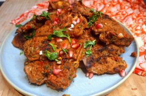 Juicy grilled lamb loin chops with a spice crust on a griddle