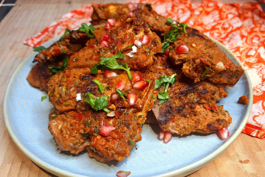 Juicy grilled lamb loin chops with a spice crust on a griddle