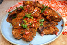 Juicy grilled lamb loin chops with a spice crust on a griddle