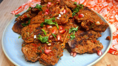Juicy grilled lamb loin chops with a spice crust on a griddle