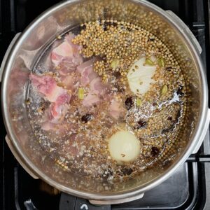 Yakhni, lamb, spices and onion in pressure cooker