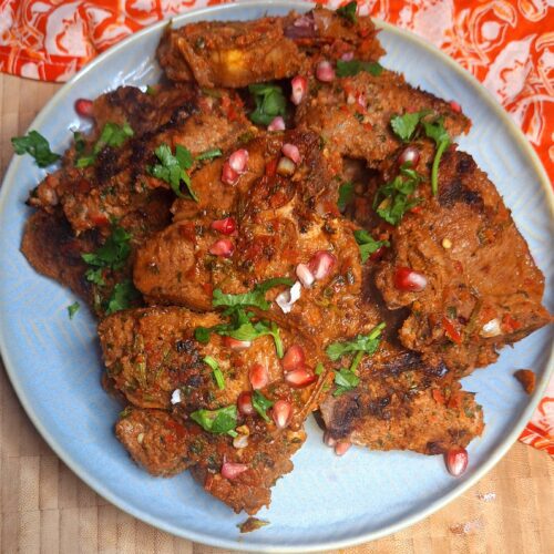 Juicy grilled lamb loin chops with a spice crust on a griddle