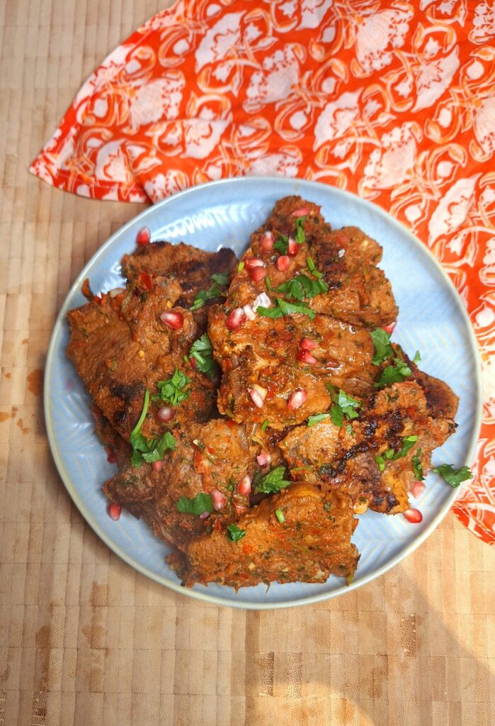 Juicy grilled lamb loin chops with a spice crust on a griddle