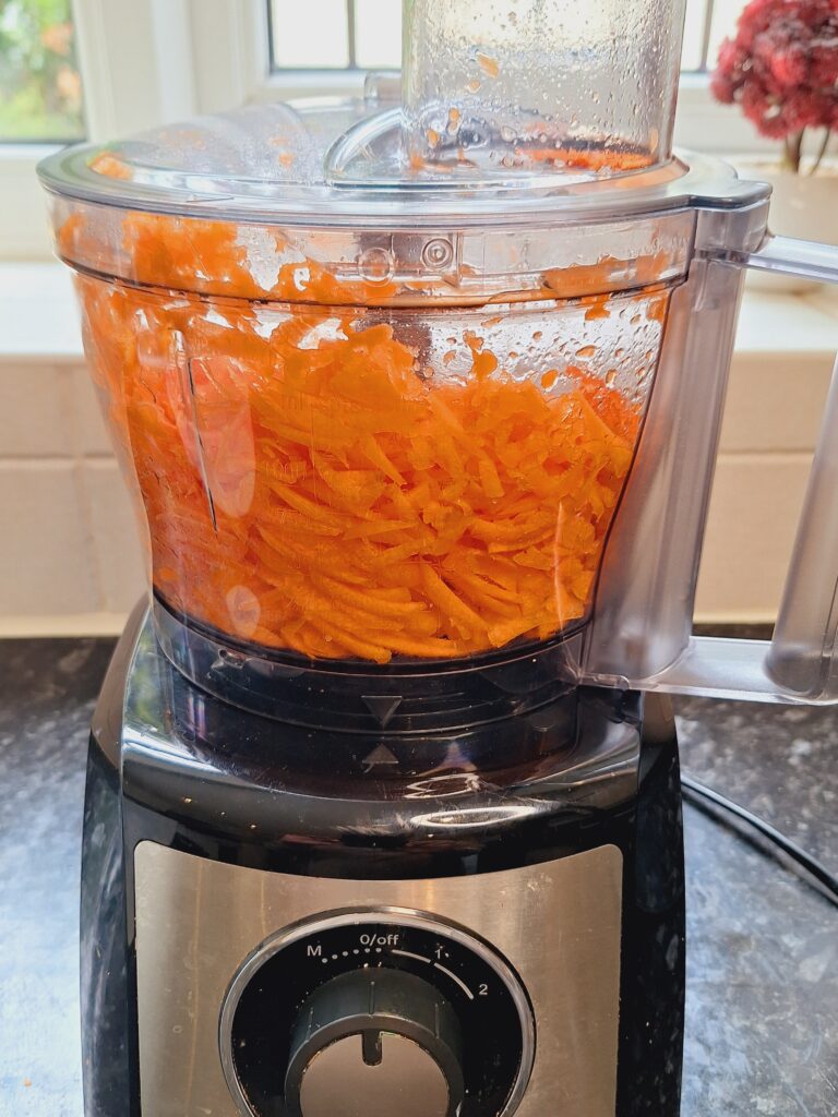 Grate carrots in food processor