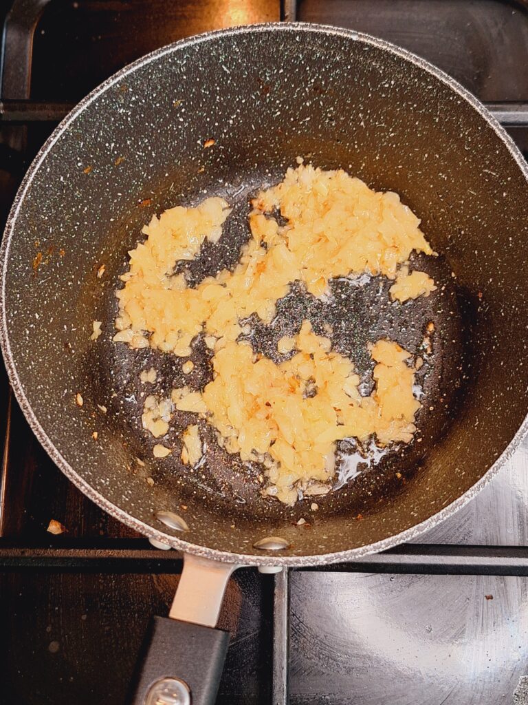 Lightly brown onions for tarka