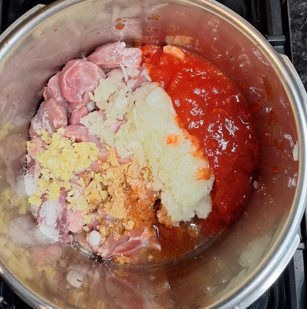 Meat, spices, tinned tomatoes and onions