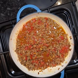 Add water and chopped tomatoes to mince