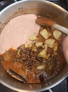 Add potatoes, spice tarka and yoghurt mixture