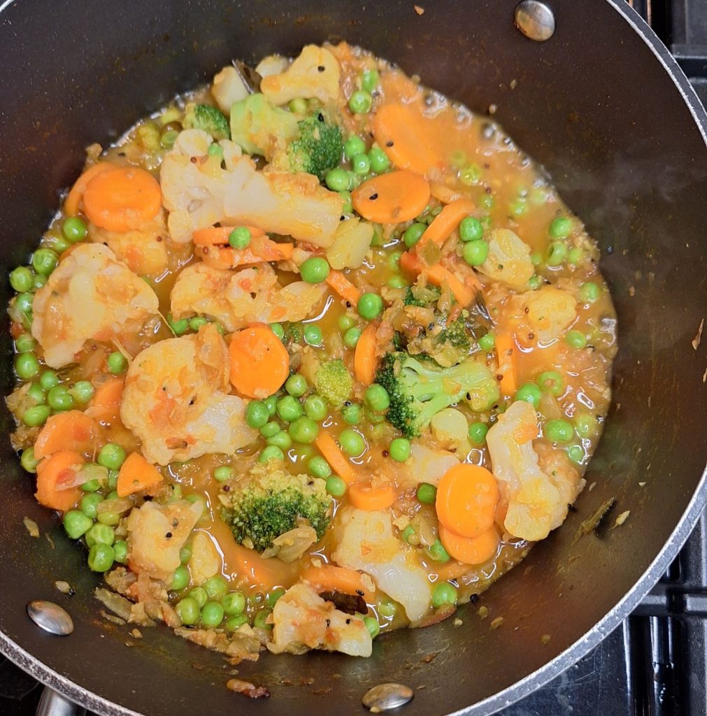 Let vegetables and masala simmer