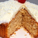 Moist coconut cake topped with shredded coconut