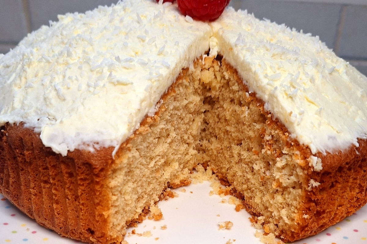 Moist coconut cake topped with shredded coconut