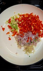 Add onions, peppers and garlic and ginger