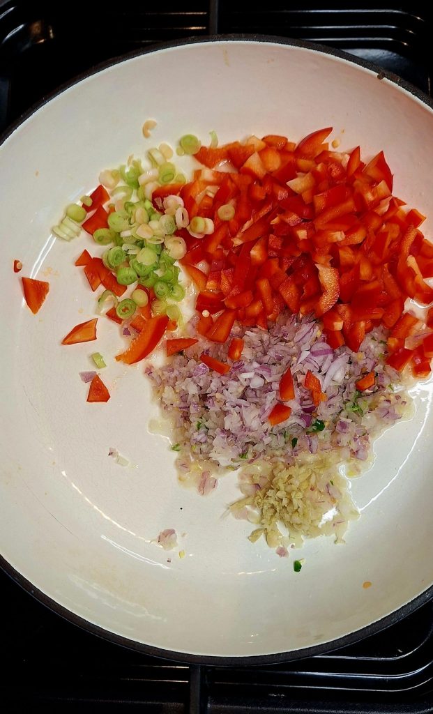 Add onions, peppers and garlic and ginger