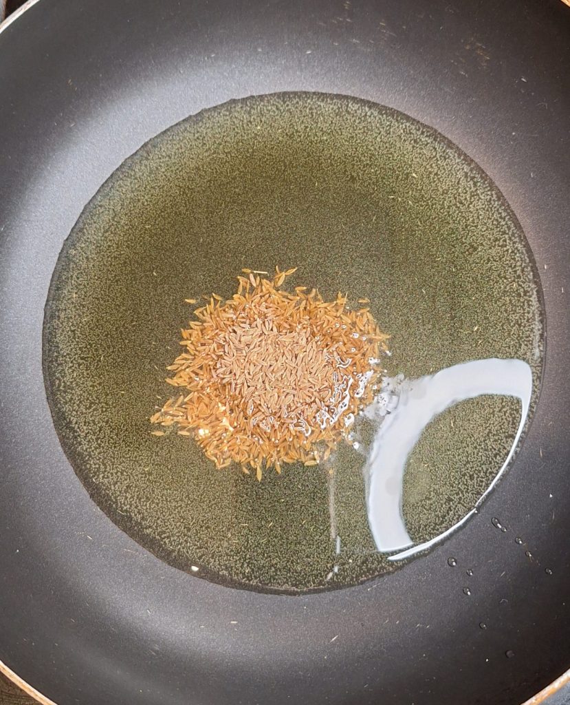 Heating cumin seeds