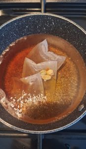 Add tea bags, cardamoms and saffron