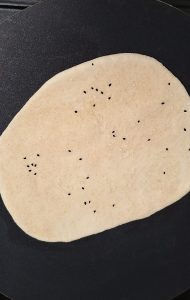 Add nigella and sesame seeds