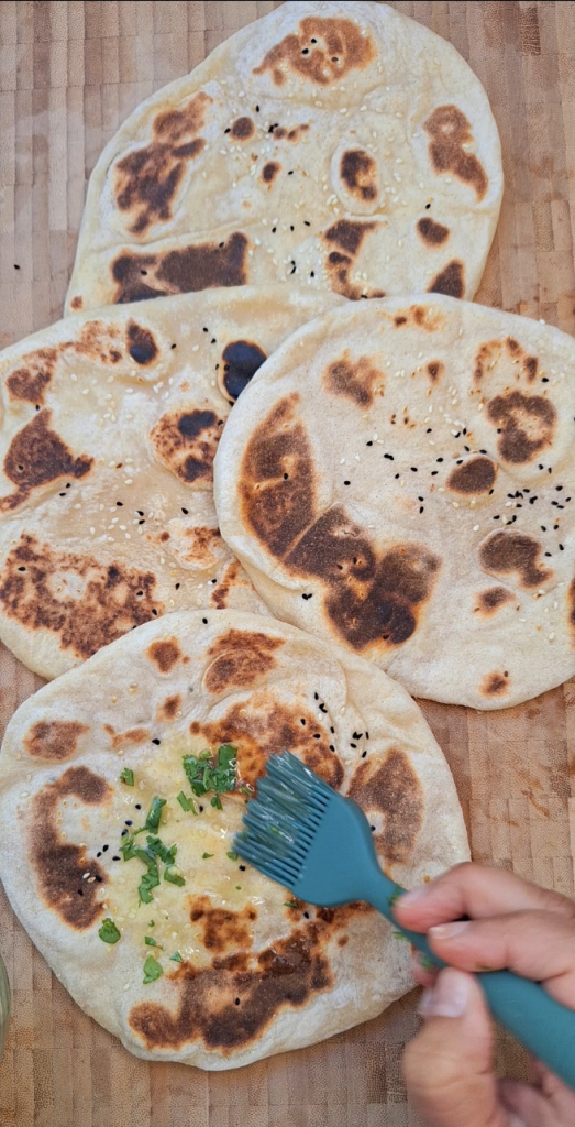 Brush garlic butter onto naan